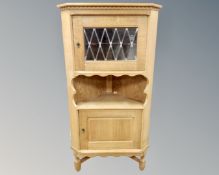 A blonde oak leaded glass corner bookcase,
