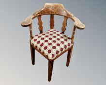 A continental oak corner armchair.