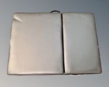 A folding black vinyl massage table.