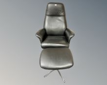 A Hjort Knudsen black leather armchair on chrome swivel base and matching footstool