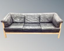 A Stouby black leather three seater settee,