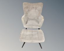 A Scandinavian armchair in grey upholstery on tapered legs with matching footstool