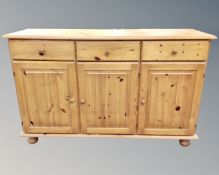 A pine three-door, three-drawer sideboard,