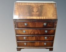 A reproduction mahogany fall fronted bureau.