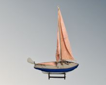 A wooden model of a sailing ship on stand.