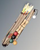 Two bundles of croquet equipment.