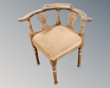 A continental carved oak corner armchair.