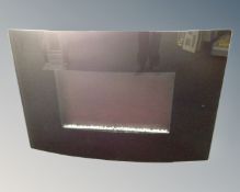 A rotisserie effect fan heater fire with remote and instructions.