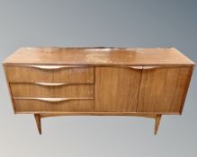 A 20th century teak low sideboard, fitted with cupboards and drawers.