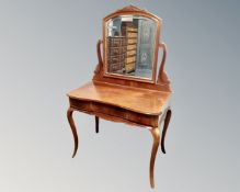 A continental mahogany serpentine front dressing table fitted with three drawers on cabriole legs.