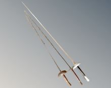 Three fencing foils.