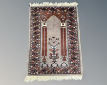 An Iranian prayer rug, 100cm by 65cm.