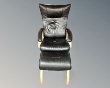 A Scandinavian black leather and beech framed armchair on swivel base with matching footstool