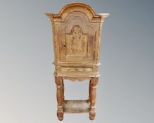A 19th century oak single door cabinet on stand,