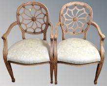 A pair of contemporary armchairs in floral upholstery.