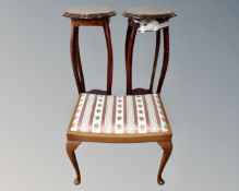 A pair of stained wood jardiniere stands together with a reproduction piano stool.