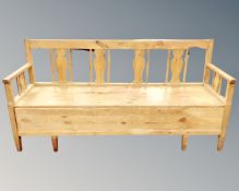 A Scandinavian pine storage settle, with tapestry cushion,