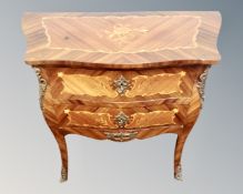 A French kingwood veneered and satinwood inlaid bombe two drawer chest with gilt metal mounts.