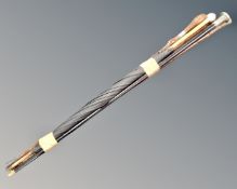A bundle of four walking sticks and an umbrella all with silver mounts.