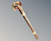 A bundle of four contemporary walking sticks together with a brass-tipped metal rod marked