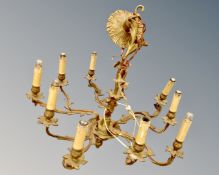An ornate brass ten branch chandelier