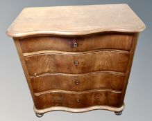 A 19th century mahogany serpentine front chest of four drawers.