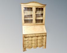 A continental blond oak leaded glass bureau bookcase.