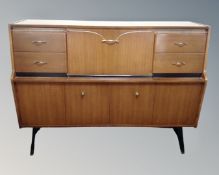 A 20th century walnut veneered cocktail sideboard.