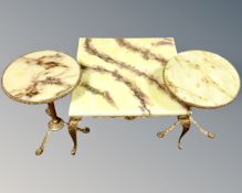 A pair of onyx and gilt brass tripod tables together with a similar square coffee table.