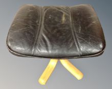 A Stouby black leather upholstered footstool