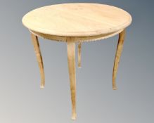 A continental blond oak circular coffee table.