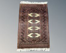 A Pakistani Lahore Bokhara rug, 103cm by 84cm.