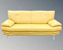 An Italian Piquattro three seater mustard-leather settee on metal legs,