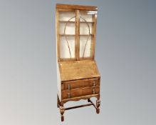 An Edwardian glazed oak bureau bookcase.
