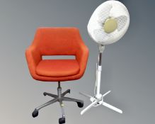 An office chair on metal base together with a floor fan.