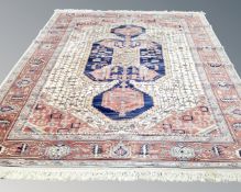 A machine made Caucasian design carpet on cream ground, 380cm by 273cm.