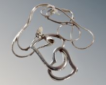 A solid silver double/floating heart necklace and pendant.