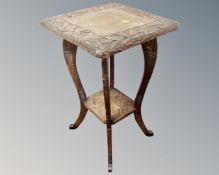 A carved beech two tier occasional table.