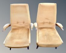 A pair of 20th century teak framed low armchairs. CONDITION REPORT: Upholstery poor.