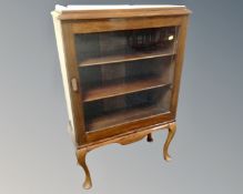 A Victorian style glazed display cabinet on cabriole legs.
