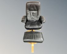 A Scandinavian black leather and beech framed armchair on swivel base with matching footstool
