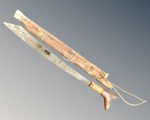 A Malaysian Penang machete in wooden sheath.