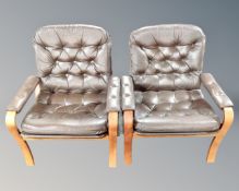 A pair of Scandinavian bentwood armchairs upholstered in brown button leather.