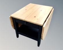 A contemporary pine effect drop leaf side table, fitted a drawer,