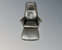 A Hjort Knudsen black leather armchair on chrome swivel base and matching footstool
