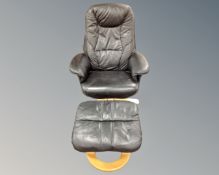 A Scandinavian black leather and beech framed swivel armchair with matching footstool