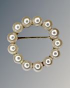 A 9ct yellow gold circular pearl brooch, width 25 mm.