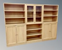 A pine effect three-section modular bookcase,