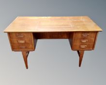 A 20th century Scandinavian teak six drawer writing desk.