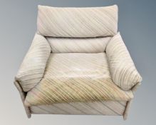A Saporiti Italian armchair upholstered in striped oatmeal fabric